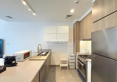 a kitchen with a refrigerator and a stove top oven at Unique 1BR in Stella Maris,City View,Dubai Marina in Dubai