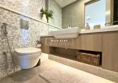 a bathroom with a toilet and a sink and a mirror at Unique 1BR in Stella Maris,City View,Dubai Marina in Dubai