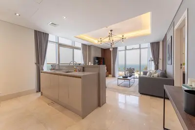 a kitchen and living room with a view of the ocean at Elegant Palm Jumeirah Retreat with Breathtaking Sea Views By AYA Boutique in Dubai