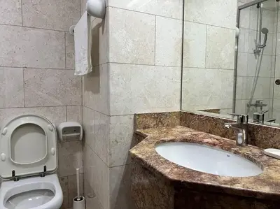 a bathroom with a sink and a toilet in it at Studio - Steps from Downtown in Dubai