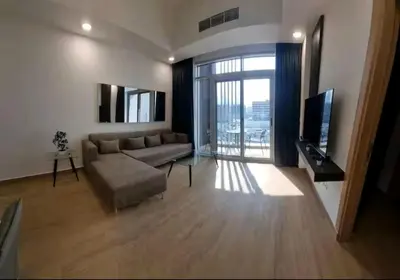 a living room with a couch and a television at 151 Residence Jumeirah Gardens in Dubai