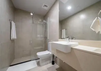 a bathroom with a sink and a shower and a toilet at 151 Residence Jumeirah Gardens in Dubai