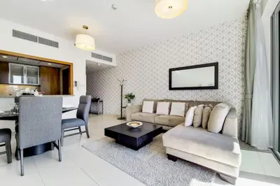 a living room with a couch and a table at Standpoint A, Downtown - Contemporary One Bedroom in Dubai