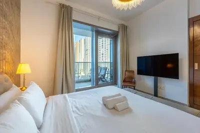 a bedroom with a white bed with a large window at Vacationer I Sparkle T1 2 Bedroom I Marina Views I Steps away from Beach I Gym, Pool, Parking & Wi-Fi in Dubai