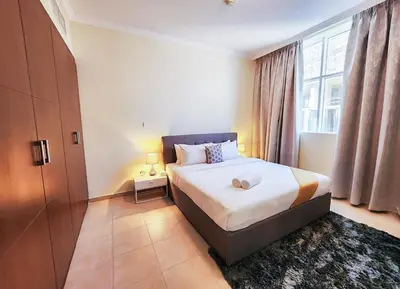 a bedroom with a bed and a large window at RH- Unwind and Relax, 1BR, Burj View from balcony, Downtown in Dubai