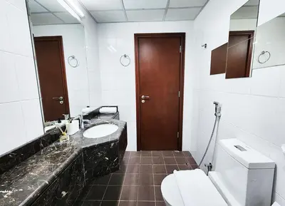 a bathroom with a toilet and a sink and a mirror at RH- Unwind and Relax, 1BR, Burj View from balcony, Downtown in Dubai