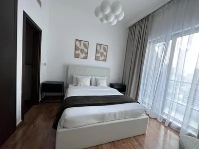 a bedroom with a large bed and a large window at Bay Central- Marina Dubai, One bed room Apartment in Dubai