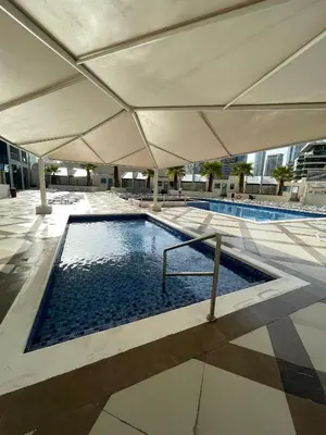 a swimming pool under an umbrella in a building at Bay Central- Marina Dubai, One bed room Apartment in Dubai