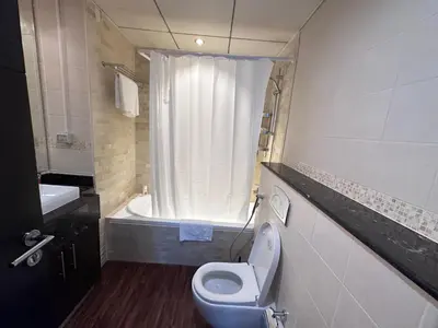 a bathroom with a toilet and a sink and a tub at Bay Central- Marina Dubai, One bed room Apartment in Dubai