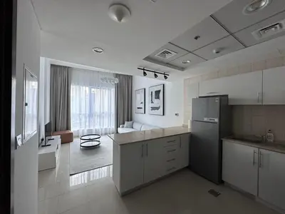 a kitchen with white cabinets and a refrigerator at Bay Central- Marina Dubai, One bed room Apartment in Dubai