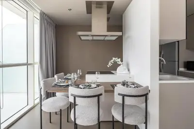 a kitchen and dining room with a table and chairs at Frank Porter - West Avenue in Dubai