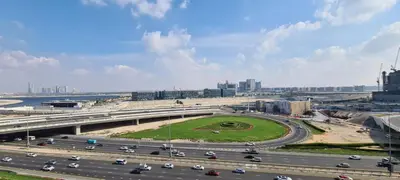 a highway in a city with cars on it at Spacious 1BR with Balcony & Rooftop Pool The Bay Business Bay in Dubai