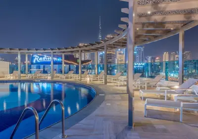 a swimming pool on the roof of a building at Spacious 1BR with Balcony & Rooftop Pool The Bay Business Bay in Dubai
