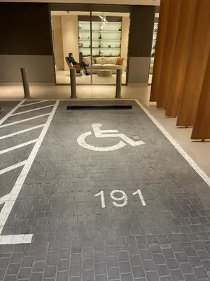 a handicapped sign on the floor of a building at STAY BY LATINEM Luxury 2BR Holiday Home CV B2302 near Burj Khalifa in Dubai