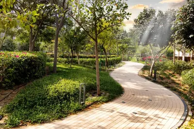 a walkway in a park with trees and flowers at STAY BY LATINEM Luxury 2BR Holiday Home CV B2302 near Burj Khalifa in Dubai