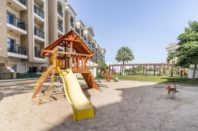 a playground with a slide and a slideintend at Superb Amenities - 1BR in Resortz by Danube,Arjan - Allsopp&Allsopp in Dubai