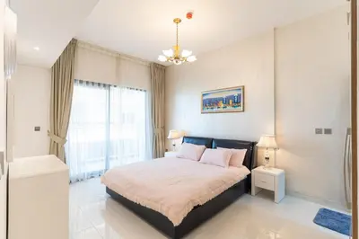 a bedroom with a large bed and a window at Superb Amenities - 1BR in Resortz by Danube,Arjan - Allsopp&Allsopp in Dubai