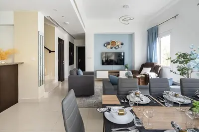 a living room with a table and chairs at Frank Porter - Serena Casa Viva in Dubai