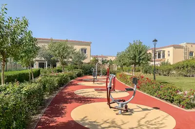 a row of exercise equipment on a path in a park at Frank Porter - Serena Casa Viva in Dubai