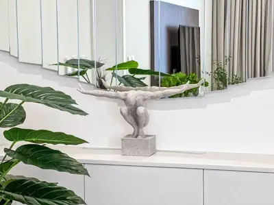 a plant sitting on a counter next to a mirror at Fantastic flat in TiaraResidence in Dubai