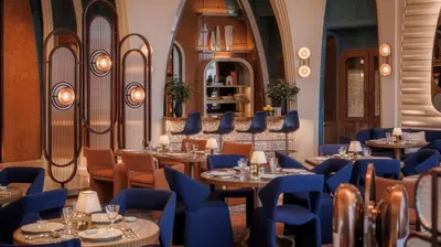a restaurant with tables and chairs and a mirror at Jumeirah Marsa Al Arab Dubai in Dubai