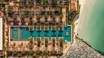 an aerial view of a resort with a pool and the ocean at Jumeirah Marsa Al Arab Dubai in Dubai