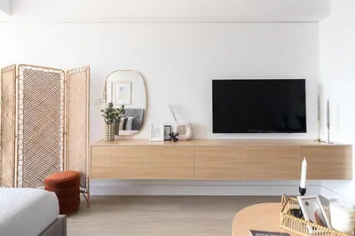 a living room with a television on a wooden cabinet at Frank Porter - Goldcrest Views 2 in Dubai