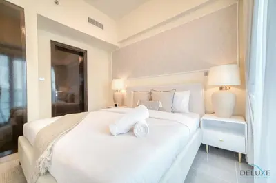 a bedroom with a white bed with two pillows on it at Graceful 1BR at Merano Business Bay by Deluxe Holiday Homes in Dubai