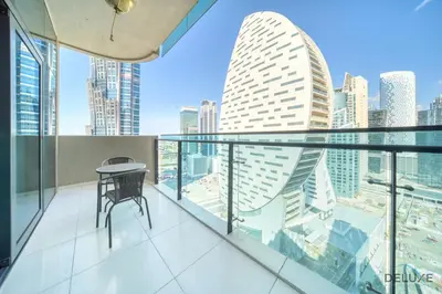 a balcony with a table and a view of a city at Graceful 1BR at Merano Business Bay by Deluxe Holiday Homes in Dubai