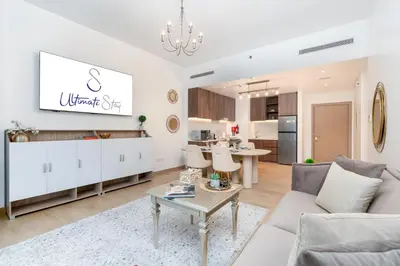 a living room with a couch and a table at Stylish 1BR Apartment in La Mer Dubai with Balcony and Partial Marina Views in Dubai