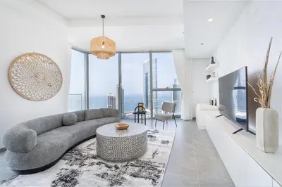 a living room with a couch and a table at Urban tropic 3 bedroom apartment with full sea view by Suiteable Interiors in Dubai