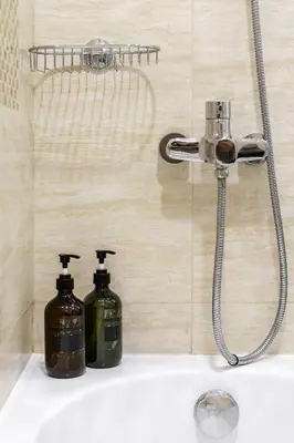 a bathroom sink with two soap bottles on it at Bright & Vibrant 2BR+kids room 7min to Dubai Mall in Dubai