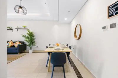 a dining room with a table and chairs at Bright & Vibrant 2BR+kids room 7min to Dubai Mall in Dubai
