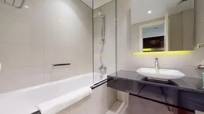 a bathroom with a sink and a bath tub at Majestine Apartments in Dubai