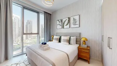 a bedroom with a large bed and a large window at Luxury 1 Bedroom Sea View and Infinity Pool in Dubai