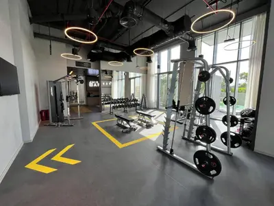 a gym with several treadmills and machines in a room at Luxury 1 Bedroom Sea View and Infinity Pool in Dubai