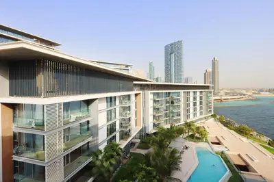 an aerial view of a building with a swimming pool at High-End 1BR Bluewaters Luxury Near Ain Dubai in Dubai