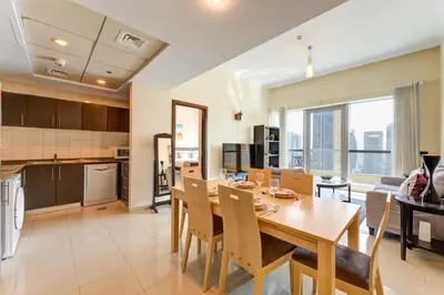 a kitchen and dining room with a table and chairs at Bay Central, Dubai Marina - Peaceful One Bedroom in Dubai