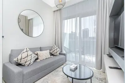 a living room with a couch and a mirror at Skyline 20thModern 1BRIconic Burj Khalifa View in Dubai