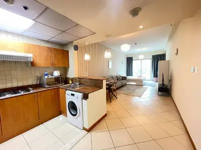 a kitchen with a washing machine in the middle of it at Amazing Largest Studio in Marina Next to Metro - Central Location in Dubai
