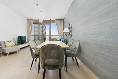 a dining room with a table and chairs at StoneTree - Marina Gate 2 BR - Partial Sea View in Dubai