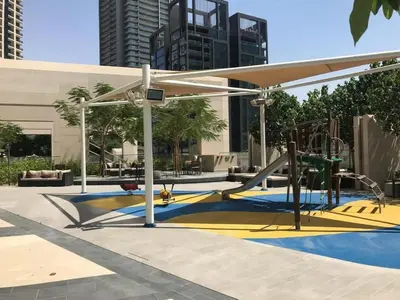a playground with a slide and a play structure at Fancy One Bedroom Apartment in Downtown Dubai By ĀYA Boutique in Dubai