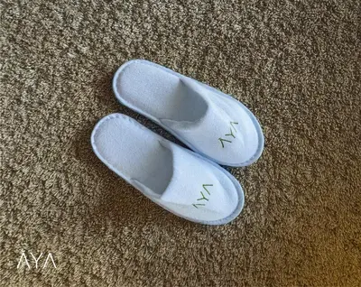 a pair of white shoes sitting on the floor at Fancy One Bedroom Apartment in Downtown Dubai By ĀYA Boutique in Dubai