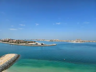 an aerial view of a body of water with a beach at Vacay Lettings - Private Beach Access -Emaar Beachfront in Dubai