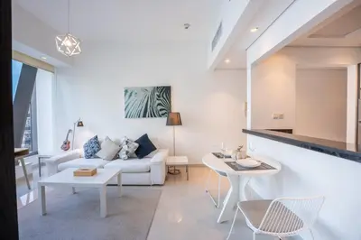 a living room with a white couch and a table at Vacationer I Elegant 1 Bedroom Apartment I Marina Views I Walk to Marina Mall I Silverene Tower B in Dubai
