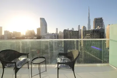 a balcony with two chairs and a view of a city at New Arabian Reva 1BR Burj Khalifa View in Dubai