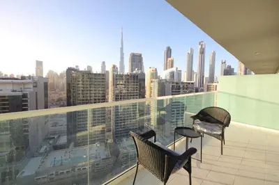 a balcony with two chairs and a view of a city at New Arabian Reva 1BR Burj Khalifa View in Dubai