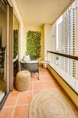 a balcony with a couch and a bench on a balcony at New sea view Rimal 2BD in front of the beach in Dubai