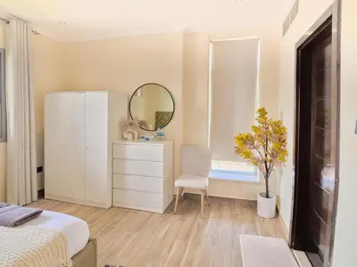 a bedroom with a bed and a mirror and a dresser at Stylish 1 BR with sea view - Sunset view in Dubai