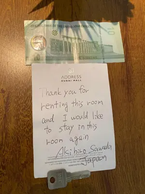 a piece of paper on a table with a money at Stylish 1 BR with sea view - Sunset view in Dubai